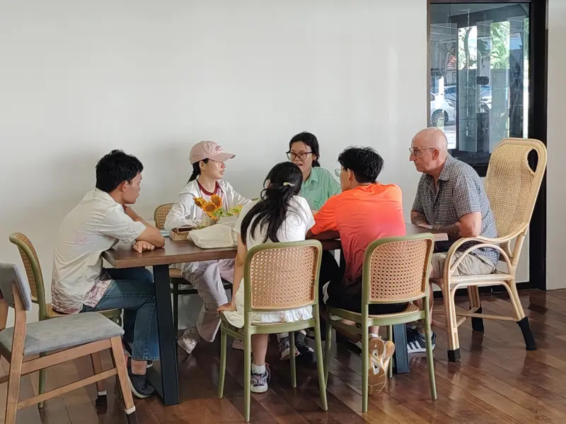 People talking around tables at the Heritage Café