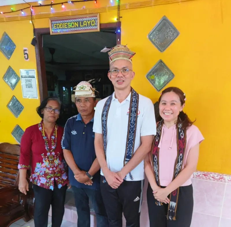 Pastor Jony and Soojin with church hosts in Sarawak, wearing traditional sashes