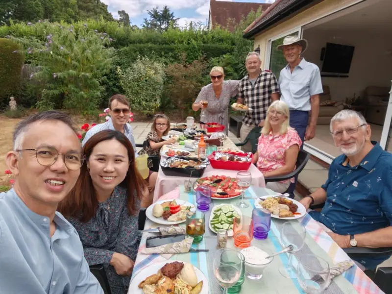 Jony and Soojin sharing a meal with partners in the UK