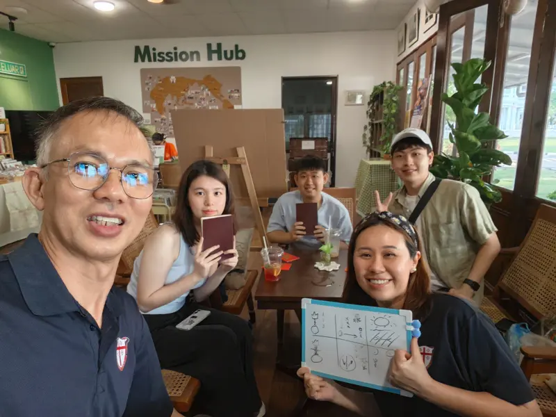 A Zúme class at the Mission Hub holding their Bibles and worksheets