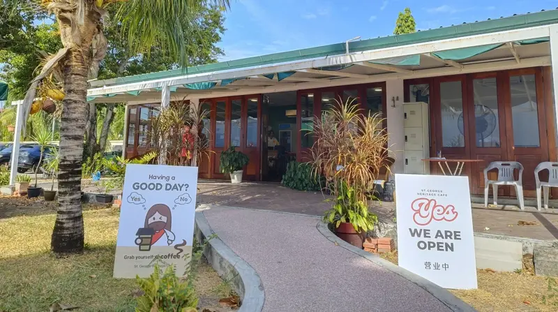 The entrance of St George Heritage Café with a 'Yes, we are open' sign