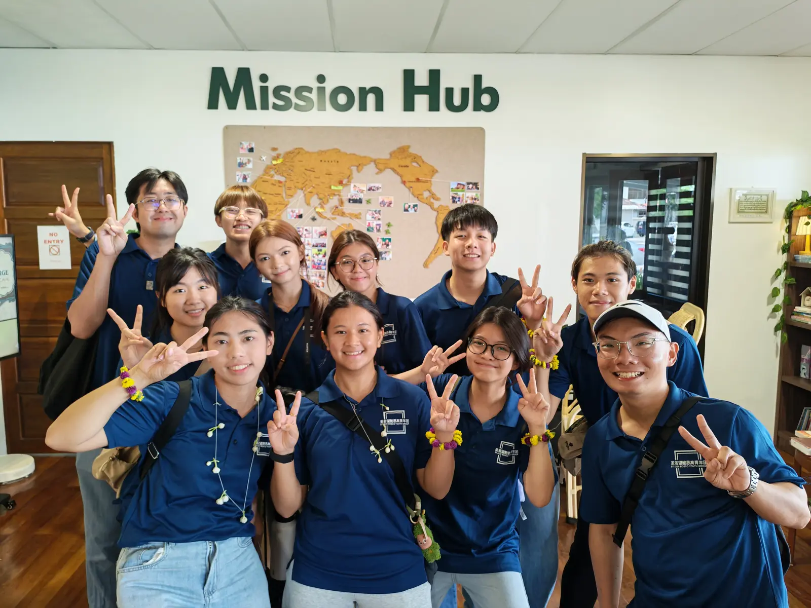 A group of young people smiling together at the Mission Hub in Penang