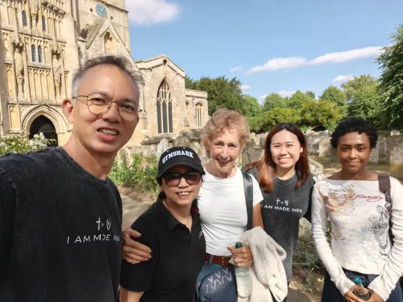 Pastor Jony with friends outside a stone church in England